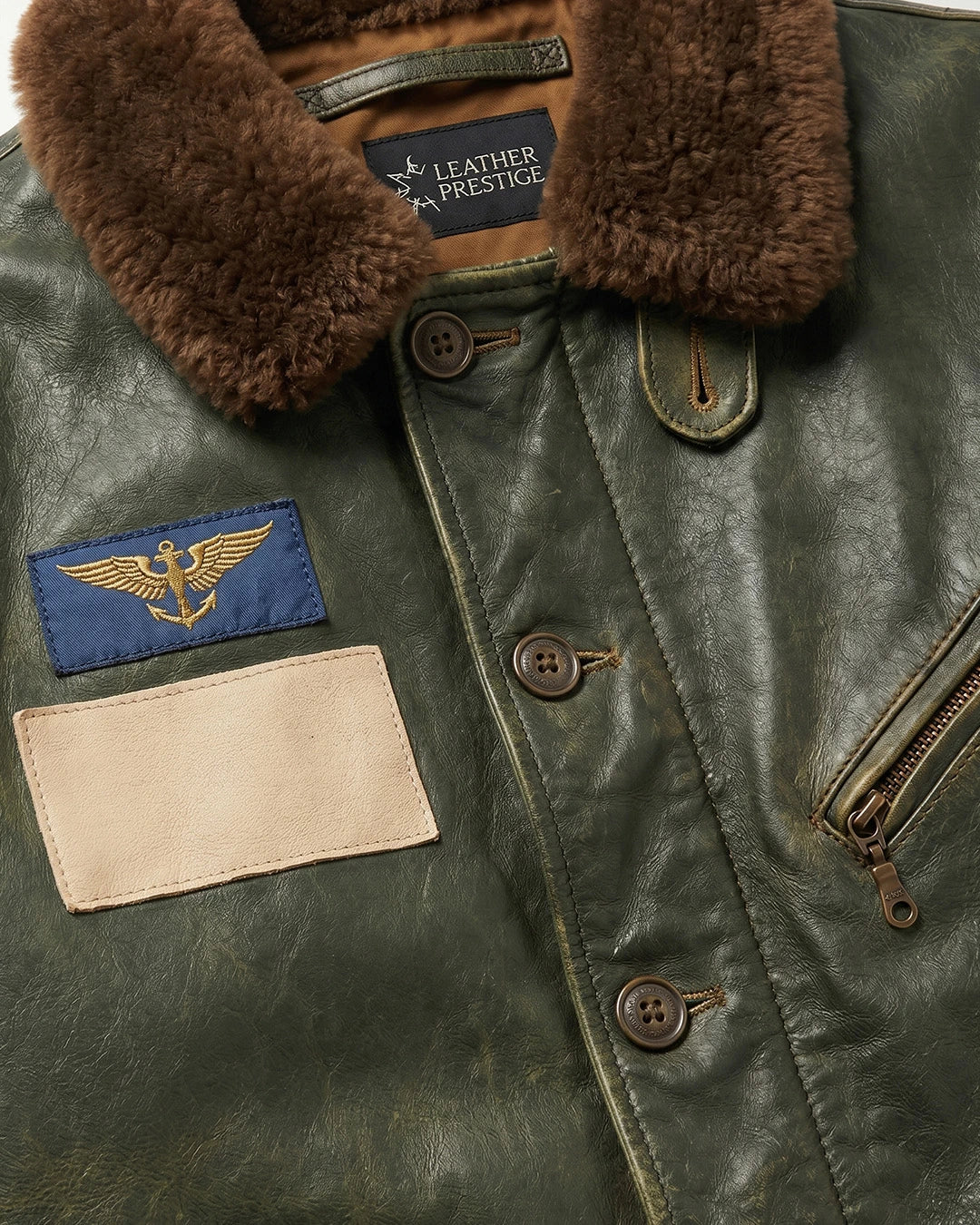 Close-up of a leather jacket with fur collar and various patches.