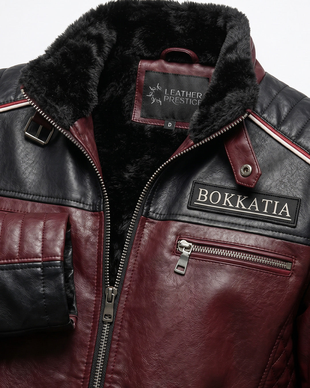 Close-up of a leather jacket with visible branding on a gray background