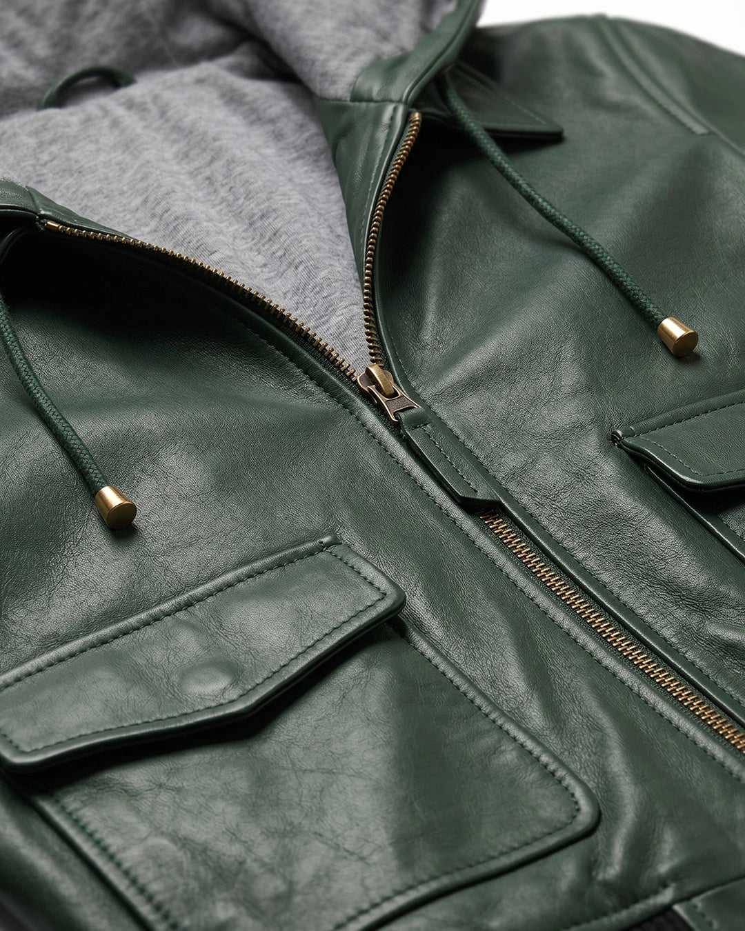 Close-up of a green leather jacket with gold zipper and hardware.