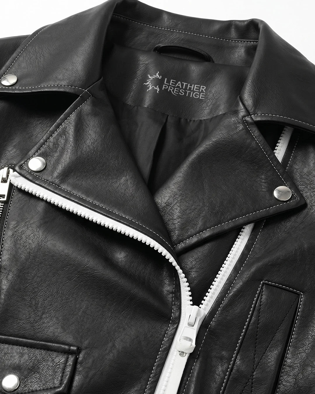 Close-up of a black leather jacket with visible branding on a white background