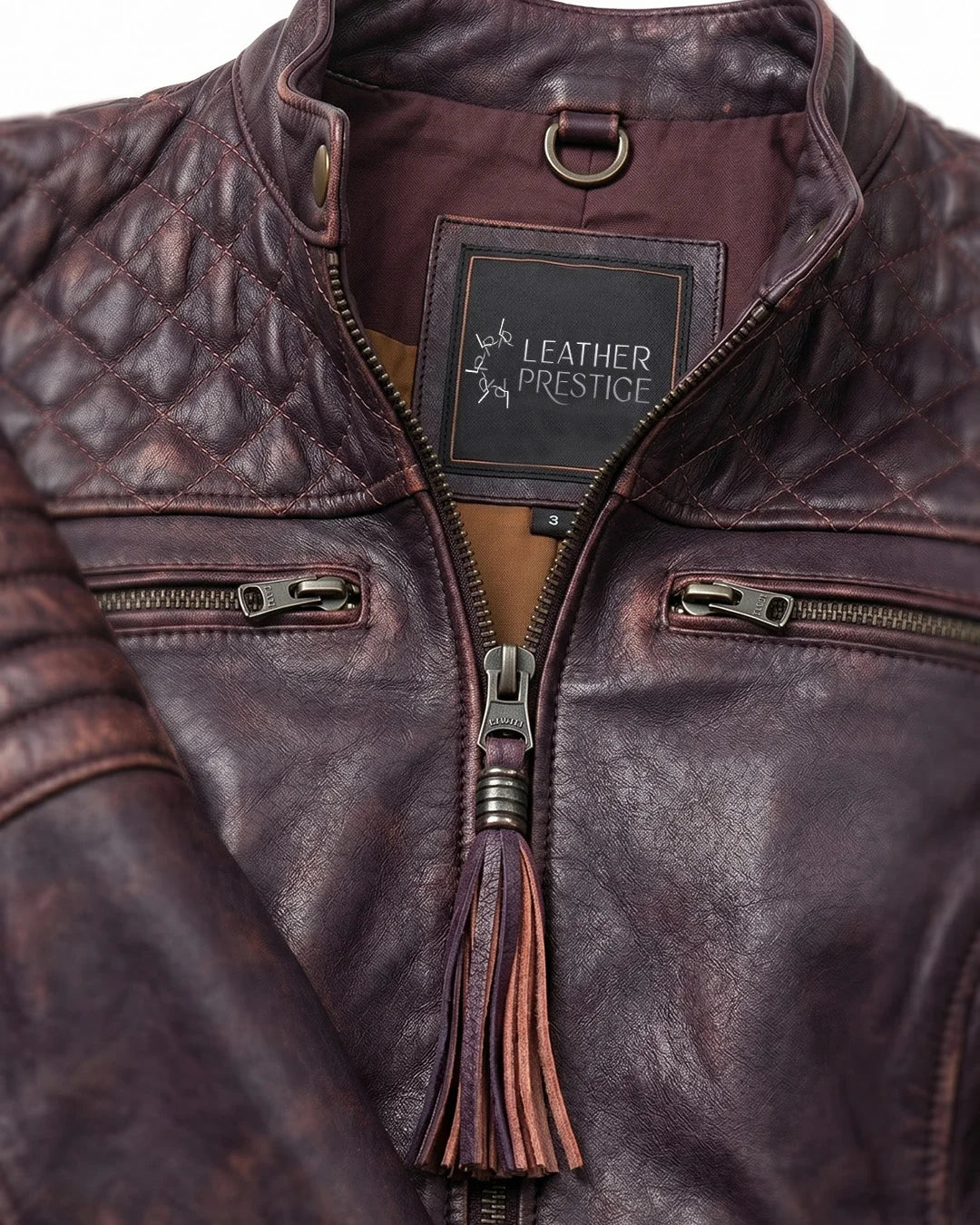 Close-up of a brown leather jacket with 'Leather Prestige' label