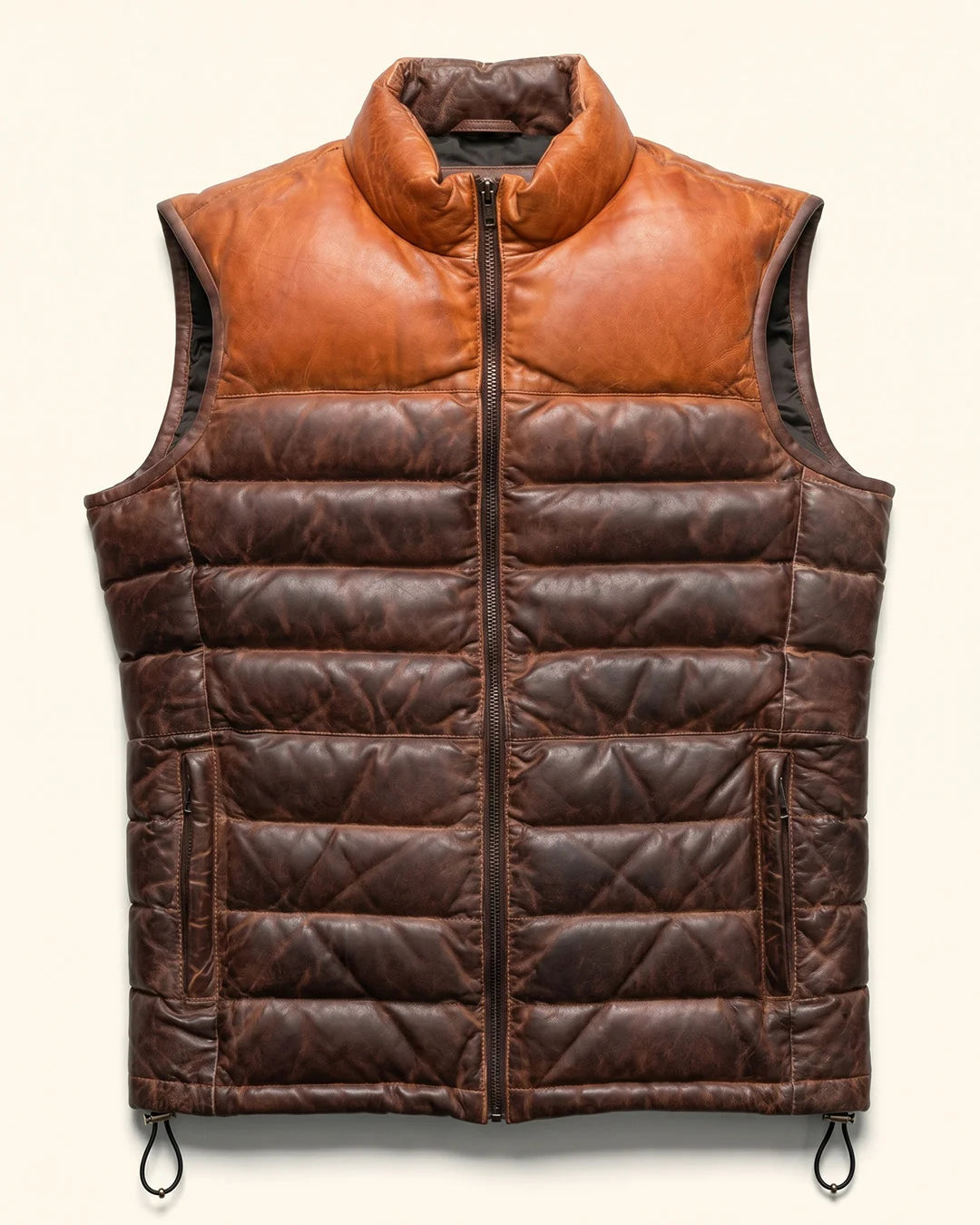 Brown leather puffer vest on a beige background