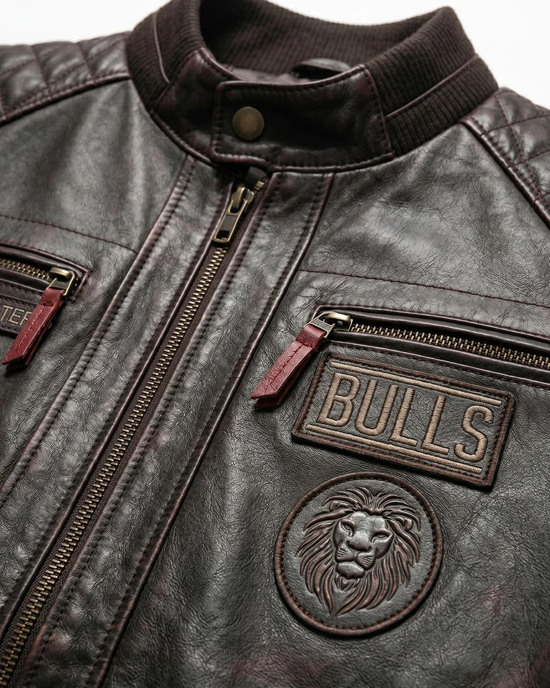 Close-up of a dark leather jacket with 'Bulls' branding and lion emblem.