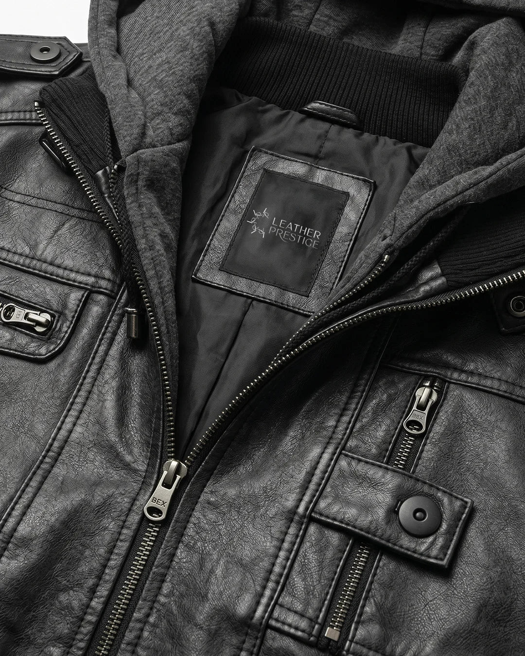 Close-up of a leather jacket with a brand logo on the chest.