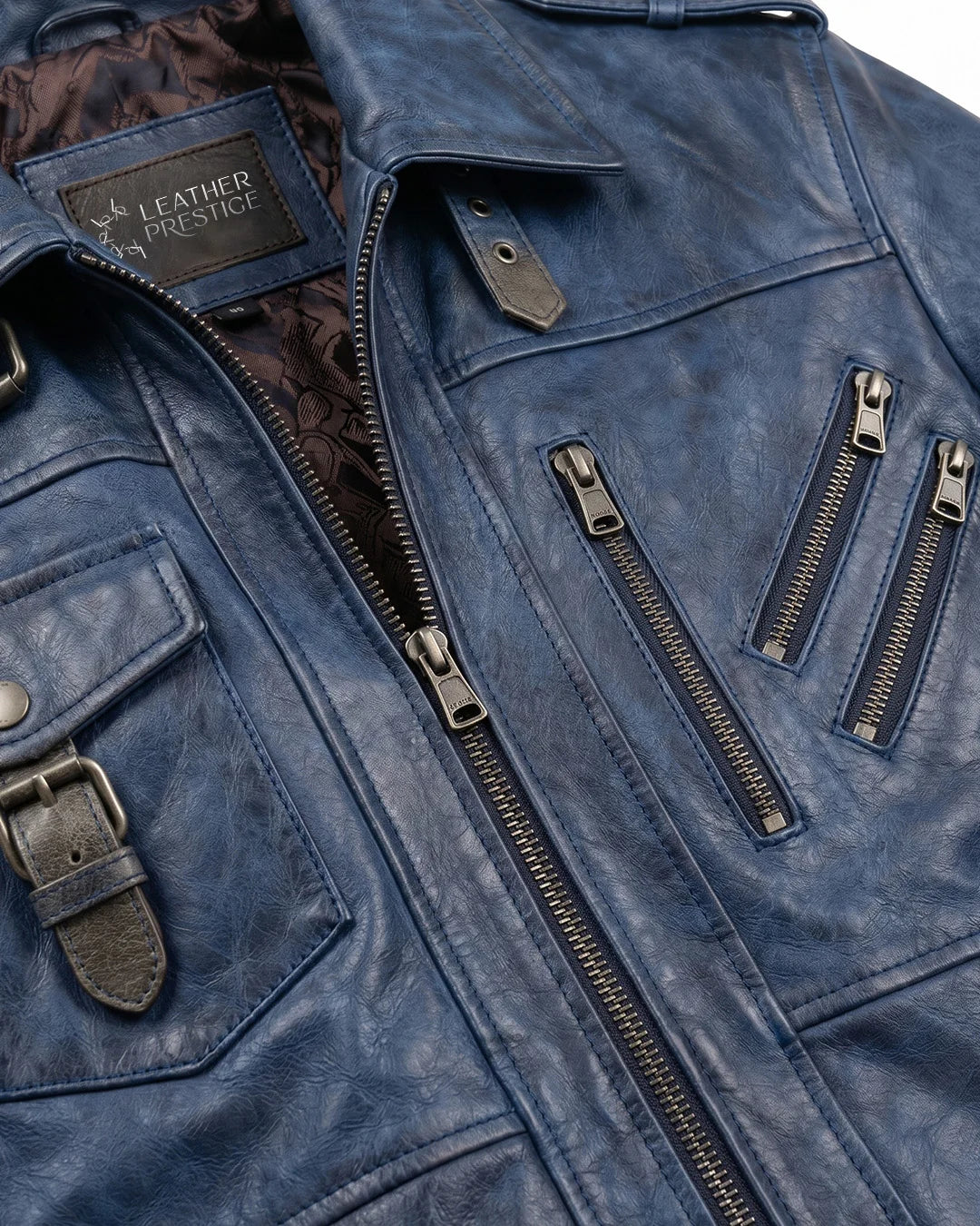 Blue leather jacket with zippers and a visible brand logo on a gray background