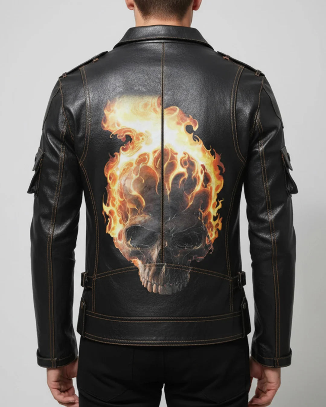 Black leather jacket with a flaming skull design on the back against a plain background
