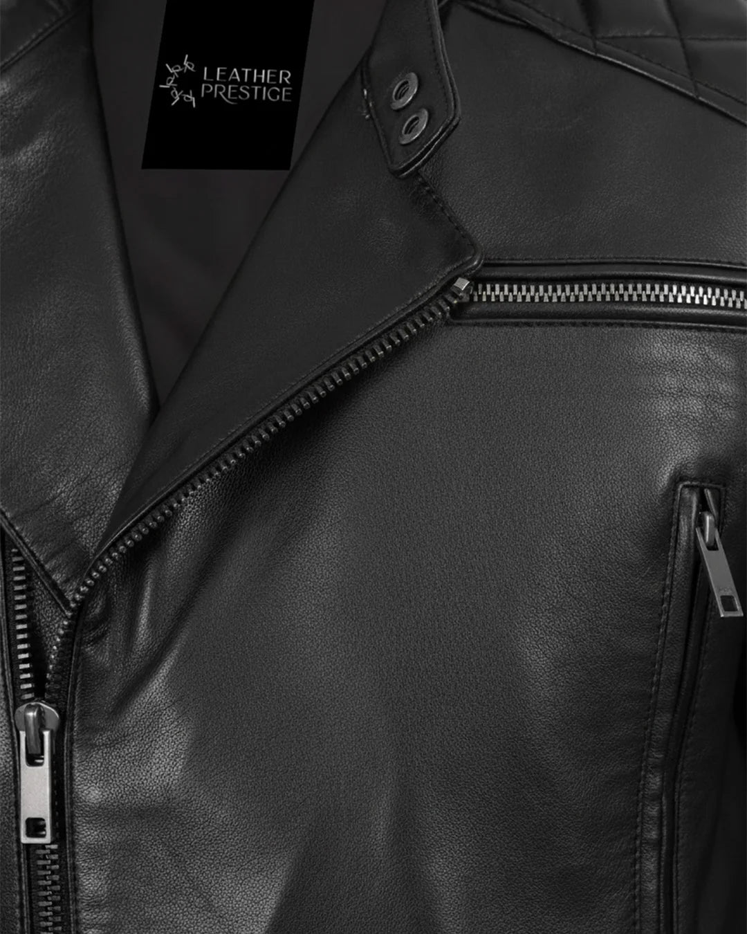 Close-up of a black leather jacket with visible branding.