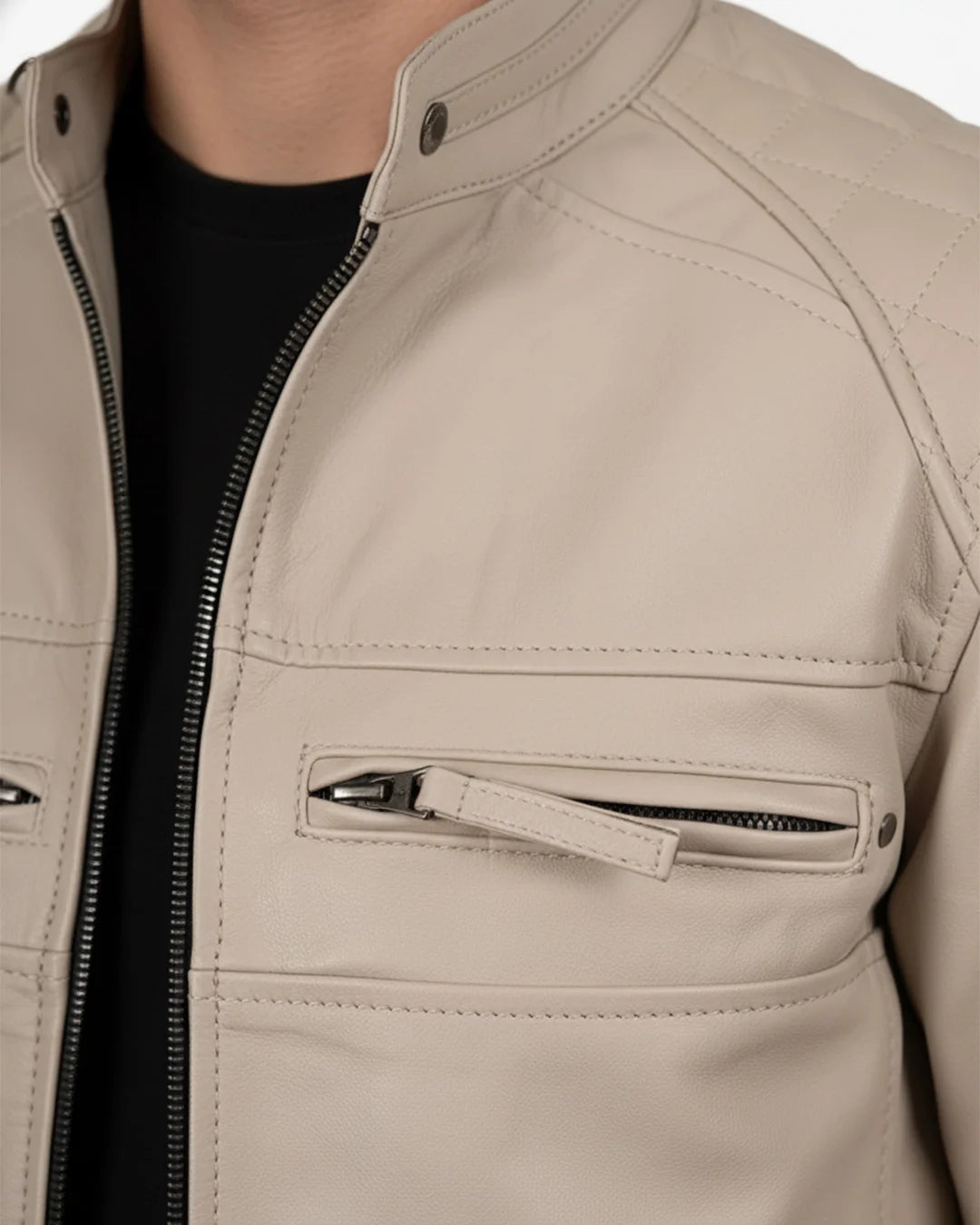 Close-up of a beige leather jacket with a zipper pocket on a white background