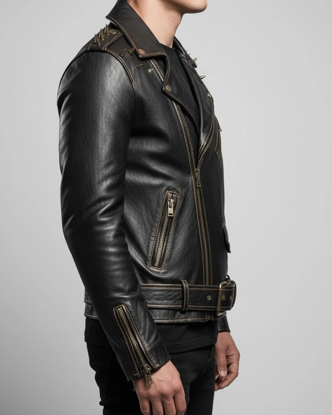 Black leather jacket with gold accents on a gray background