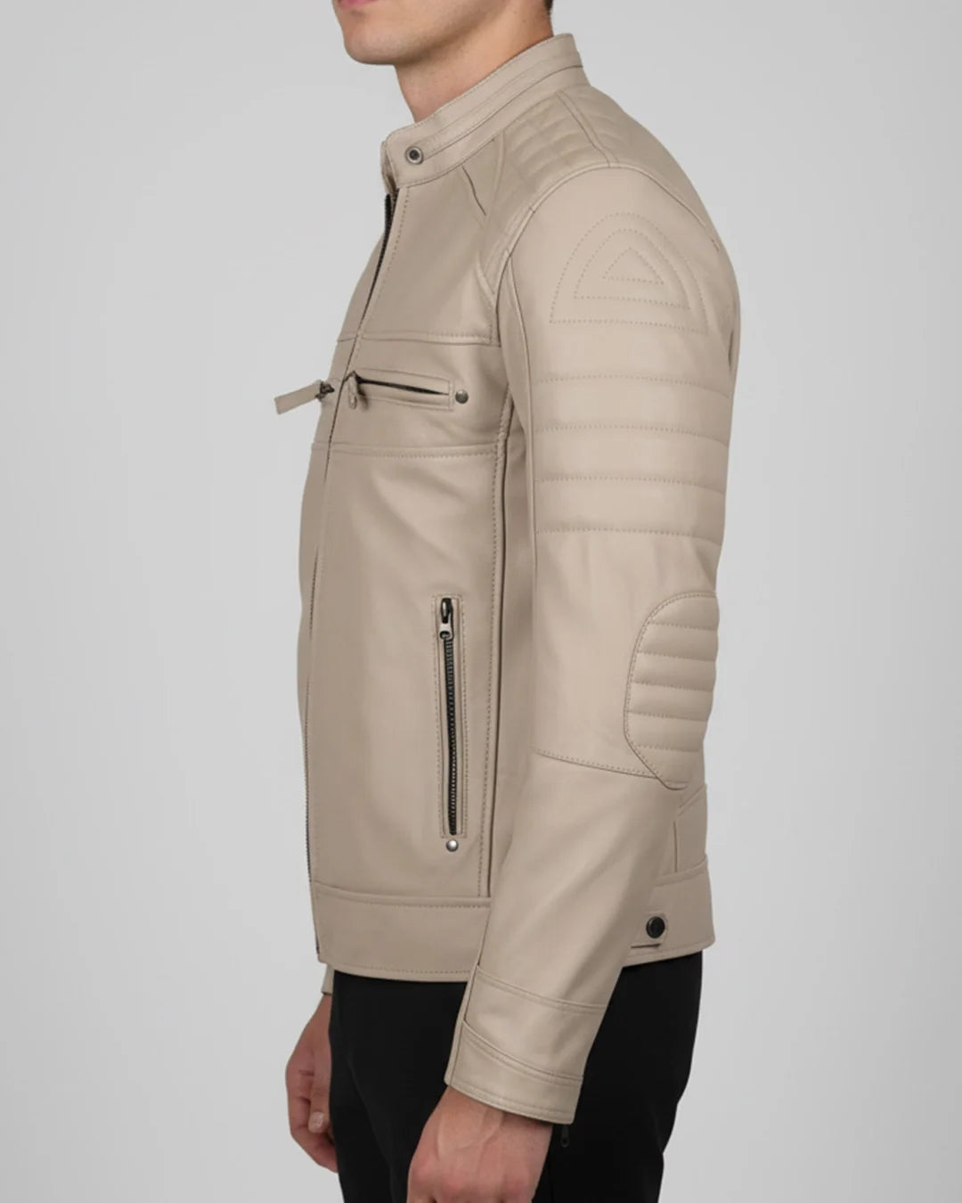 Beige leather jacket worn by a person on a light gray background