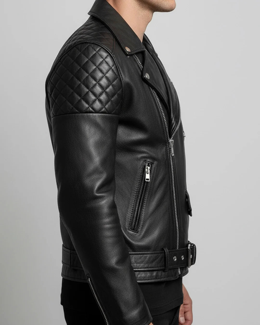 Black leather jacket with quilted shoulder design on a gray background