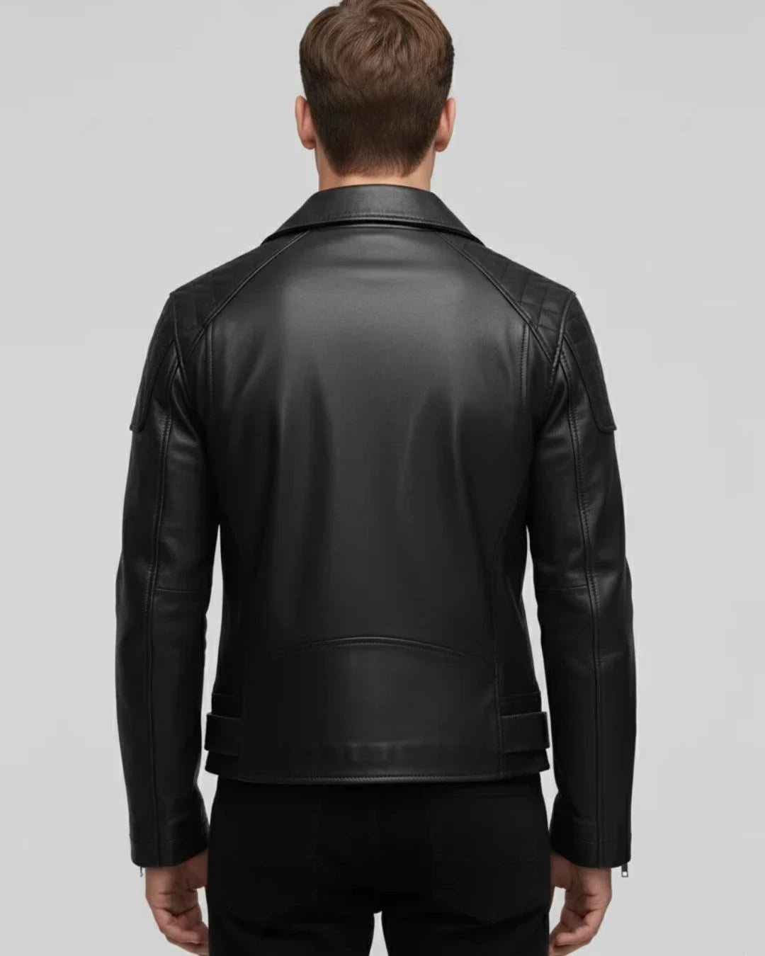 Black leather jacket worn by a person on a gray background