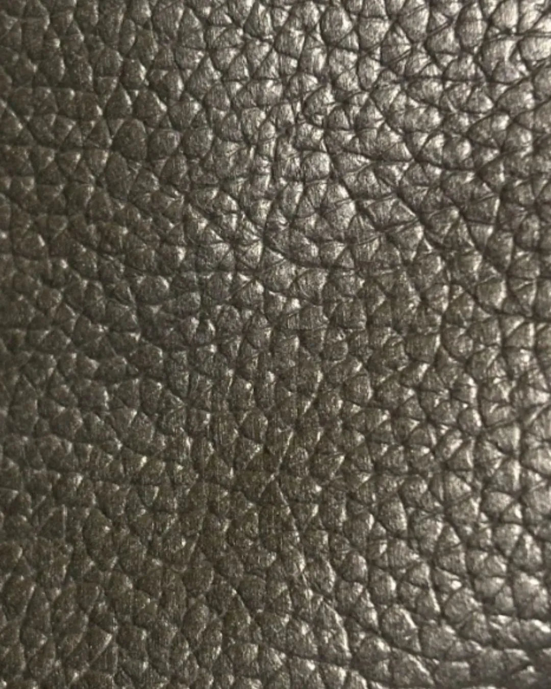 Close-up of textured dark brown leather surface