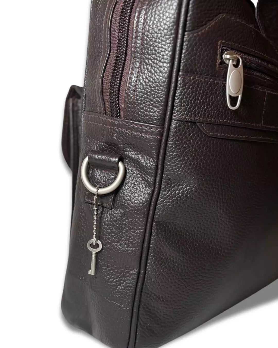 Close-up of a dark brown leather handbag with a silver clasp and keychain on a white background