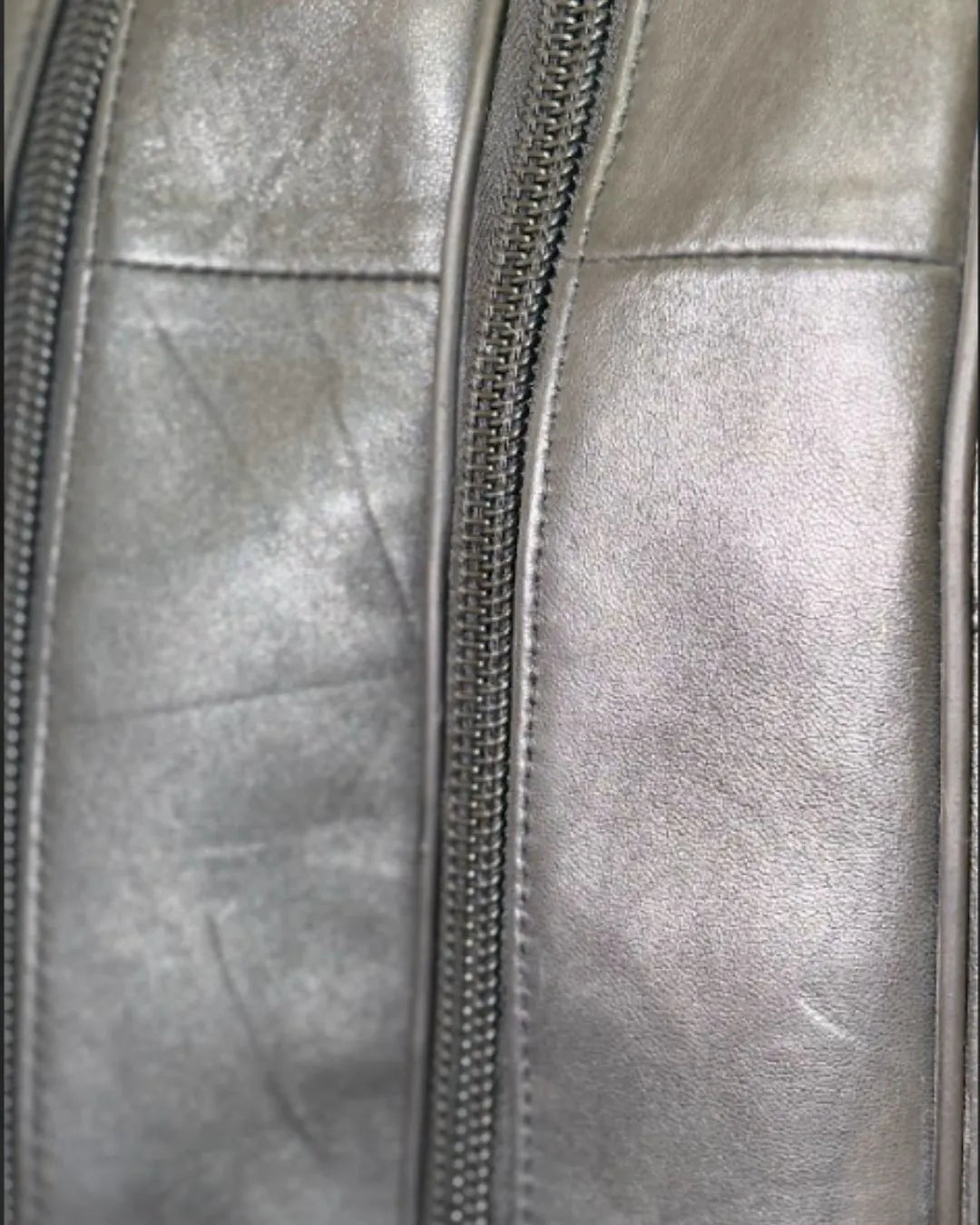 Close-up of a silver metallic jacket with a zipper