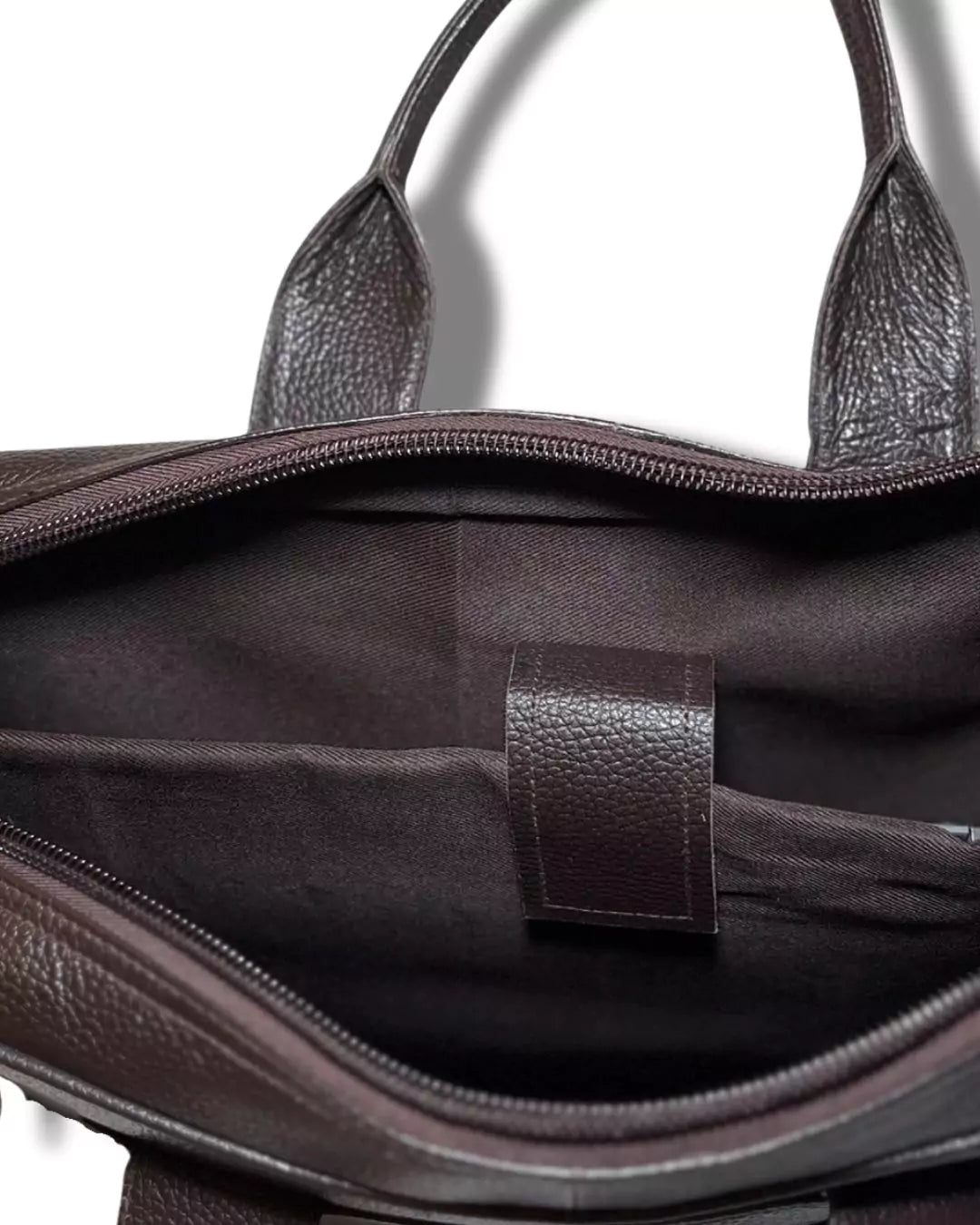 Close-up of a brown leather handbag with a visible brand logo.