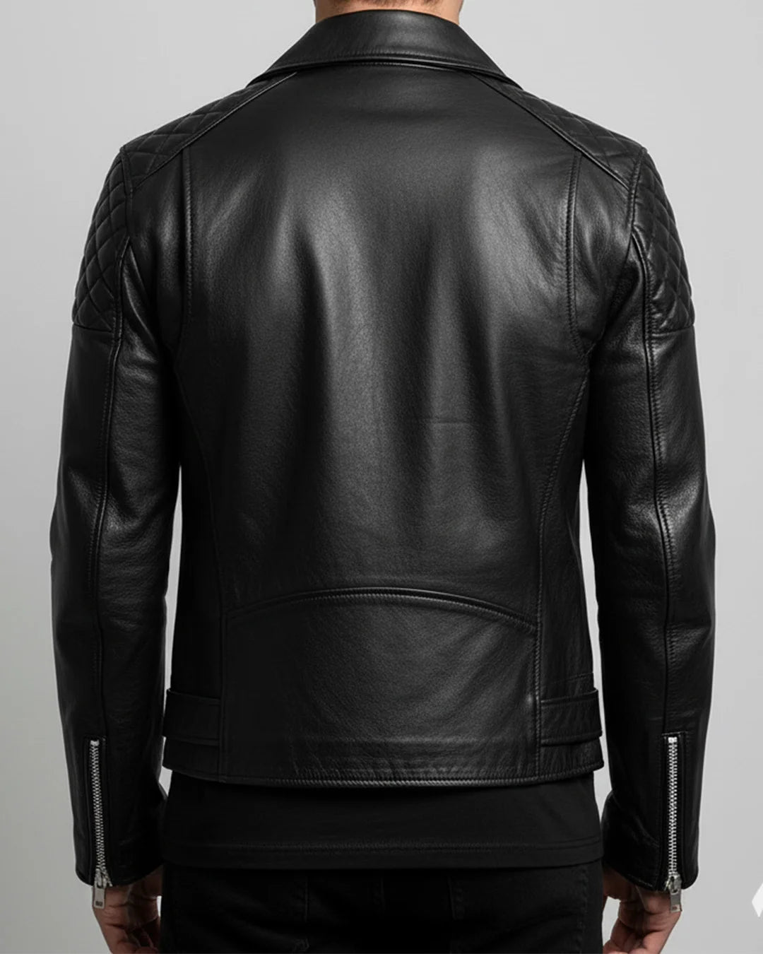 Black leather jacket worn by a person on a gray background