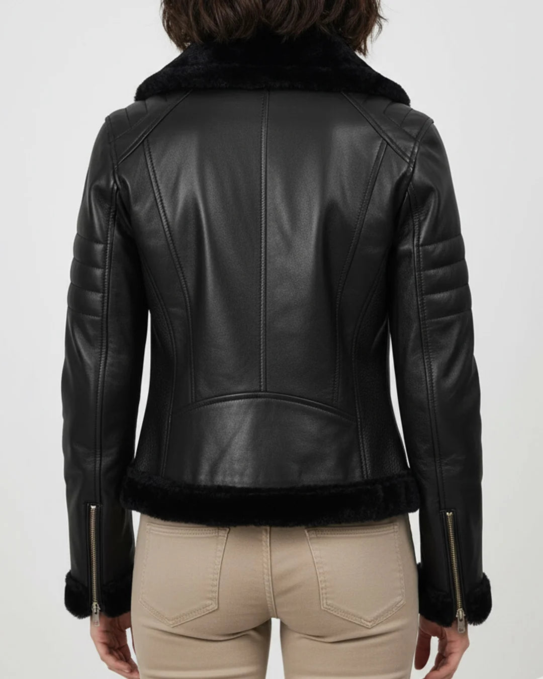 Black leather jacket with fur collar worn by a person on a white background