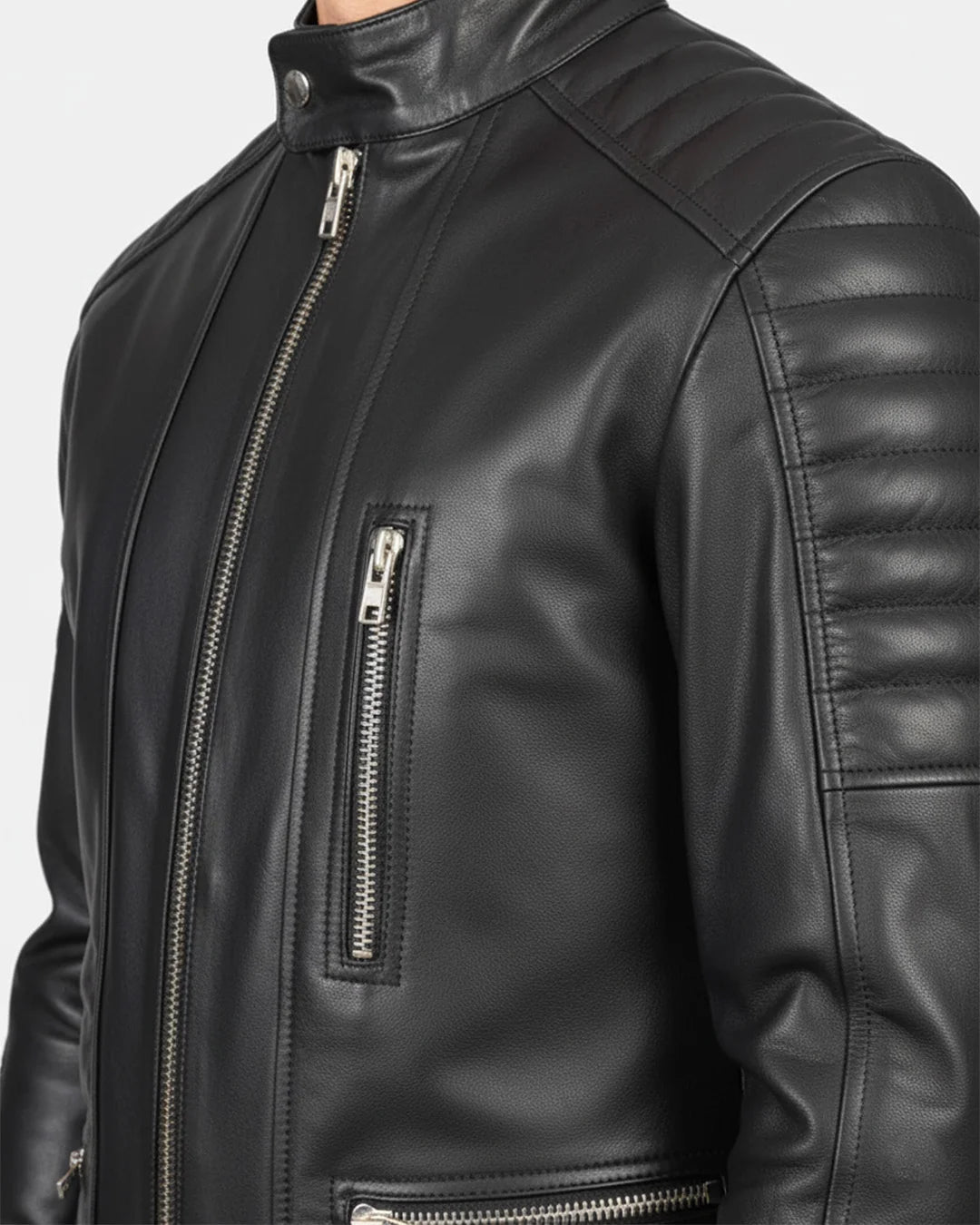 Close-up of a black leather jacket with zippers on a white background