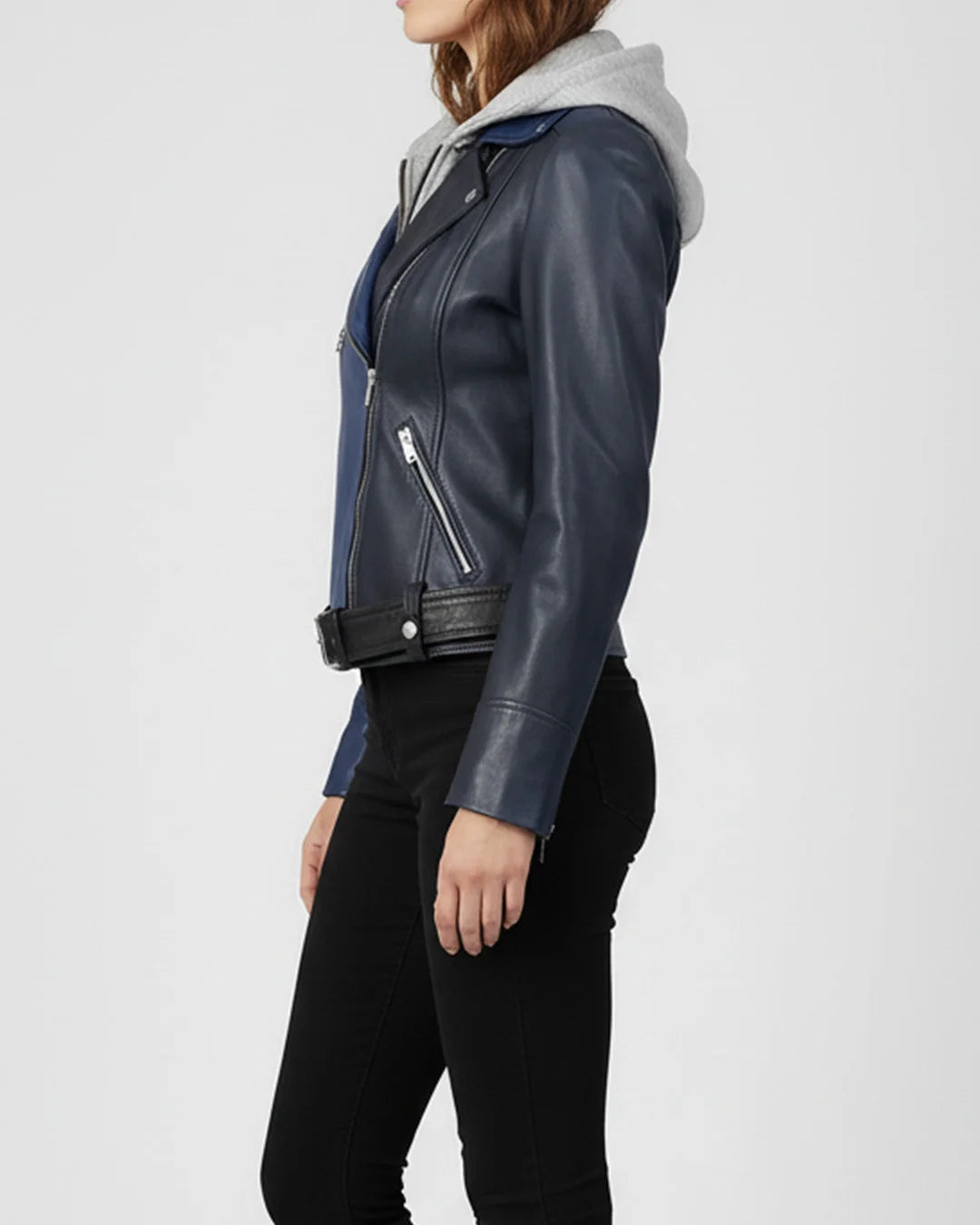 Person wearing a black and blue leather jacket on a white background
