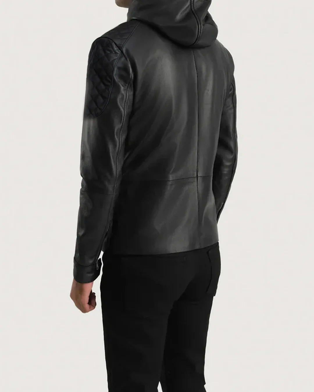 Person wearing a black leather jacket on a light gray background